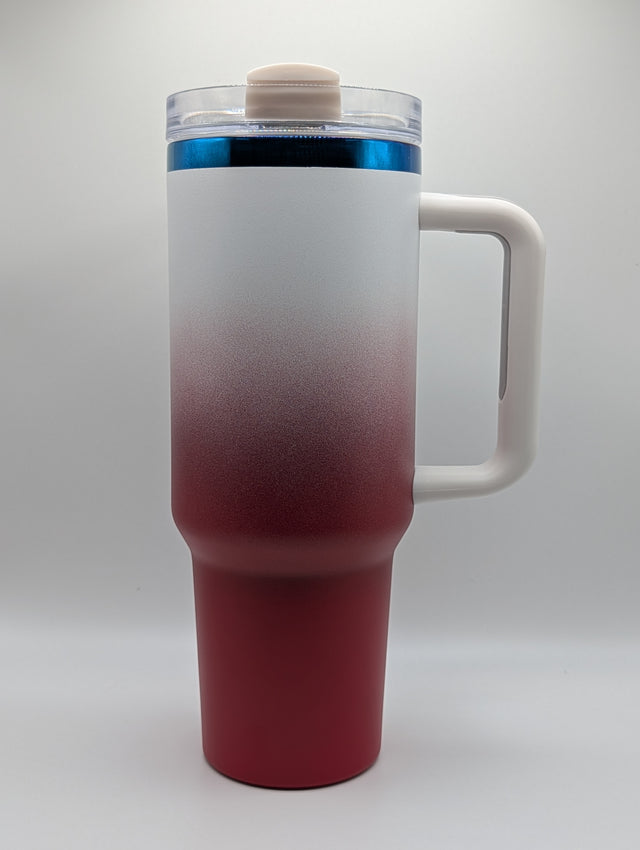A travel tumbler with a frosted white to deep red gradient finish, featuring a white handle, a clear lid with a beige cap, and a blue accent ring near the top.